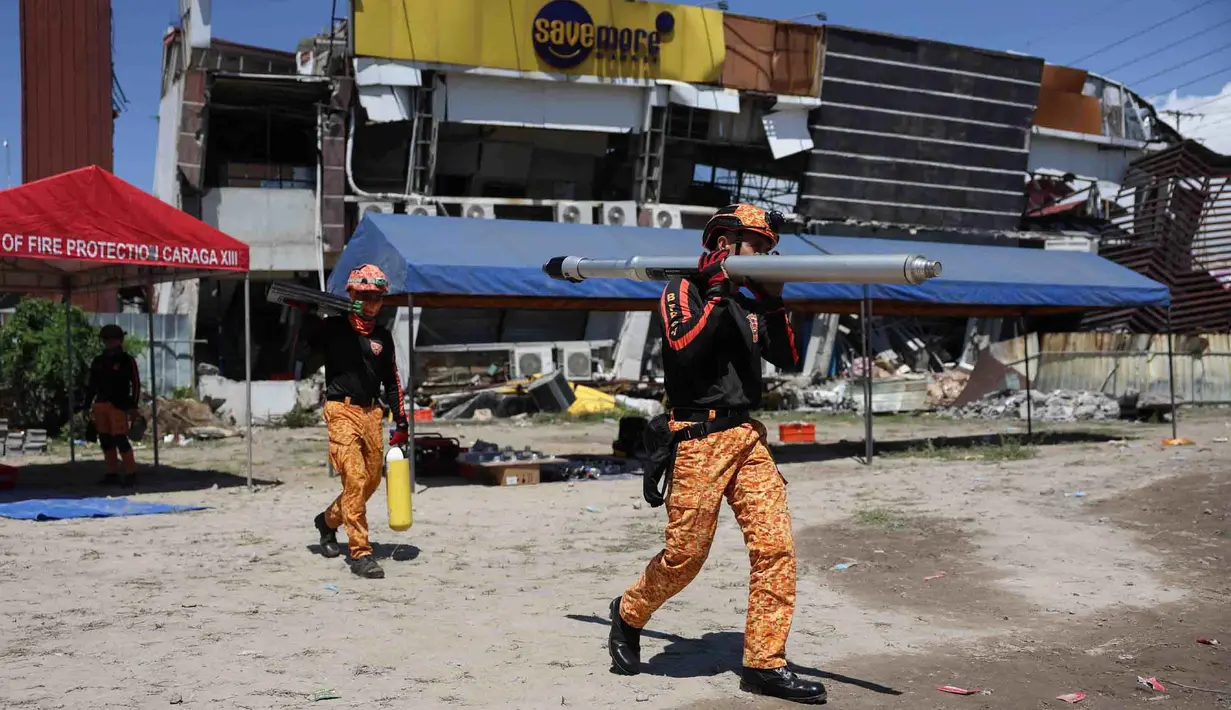 Tim penyelamat mempersiapkan peralatan mereka untuk operasi pencarian di sebuah bangunan yang rusak akibat gempa bumi di General Santos, Filipina, Selasa, 9 Juni 2026. (AP Photo/Basilio Sepe)