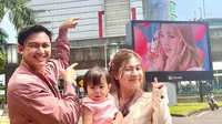 Felicya Angelista bersama suami dan anak berpose di videotron yang menampilkan TWICE sebagai duta Scarlett. (Foto: Dok. Koleksi Pribadi Felicya Angelista)