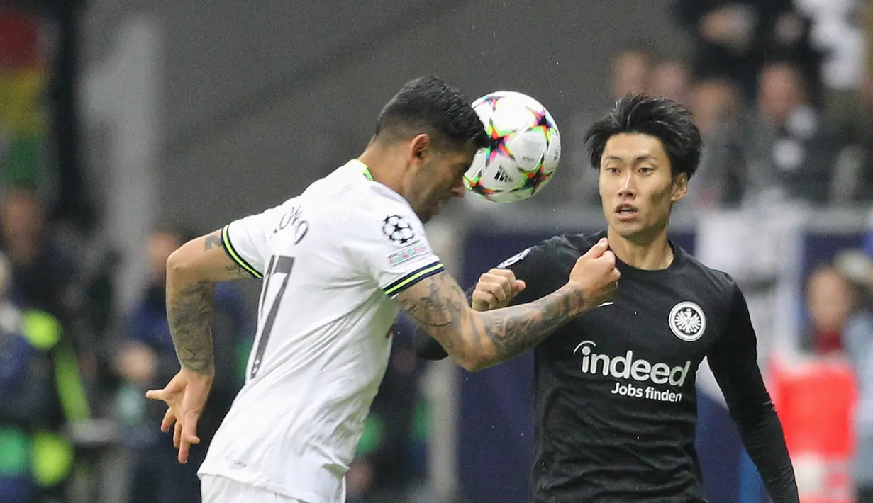<p>Bek Tottenham Hotspur Cristian Romero berebut bola dengan gelandang Eintracht Frankfurt Daichi Kamada pada laga lanjutan fase Grup D Liga Champions 2022/2023 di Waldstadion, Rabu (5/10/2022) dini hari WIB. Eintracht Frankfurt dan Tottenham Hotspur harus puas berbagi poin usai bermain imbang 0-0. (Daniel ROLAND / AFP)</p>