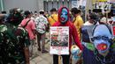Massa Aliansi Mahasiswa Islam (AMI) mengenakan topeng saat menggelar aksi di depan Kedutaan Besar China, Jakarta, Jumat (14/1/2022). Massa juga meminta pemerintah Indonesia memboikot Olimpiade Musim Dingin 2022 serta menghentikan deportasi terhadap pencari suaka Uighur. (Liputan6.com/Faizal Fanani)