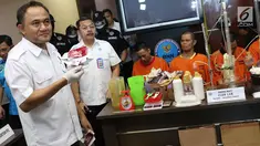 Kepala BNN Komjen Pol Heru Winarko (kiri) menunjukkan barang bukti beserta tersangka kasus pabrik gelap narkoba di Majene di Gedung BNN Jakarta, Kamis (9/8). Petugas berhasil menangkap empat tersangka. (Liputan6.com/Immanuel Antonius)
