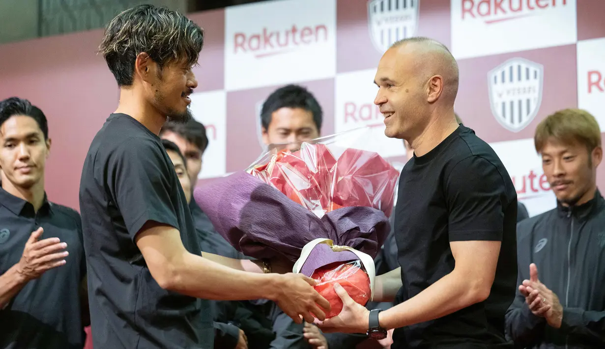 Pemain Vissel Kobe, Andres Iniesta menerima kenang-kenangan dari rekan setimnya setelah konferensi pers mengenai kepergian dirinya dari klub yang berlangsung di Kobe, 25 Mei 2023 waktu setempat. (AFP/Yuichi Yamazaki)