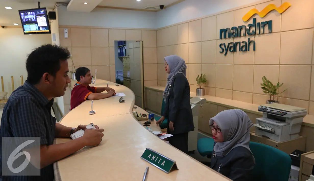 Petugas melayani nasabah di Bank Mandiri Syariah di Jakarta, Kamis (14/7). Sejumlah bank syariah mengaku siap menjadi bank persepsi, Jakarta, Kamis (14/7). (Liputan6.com/Angga Yuniar)