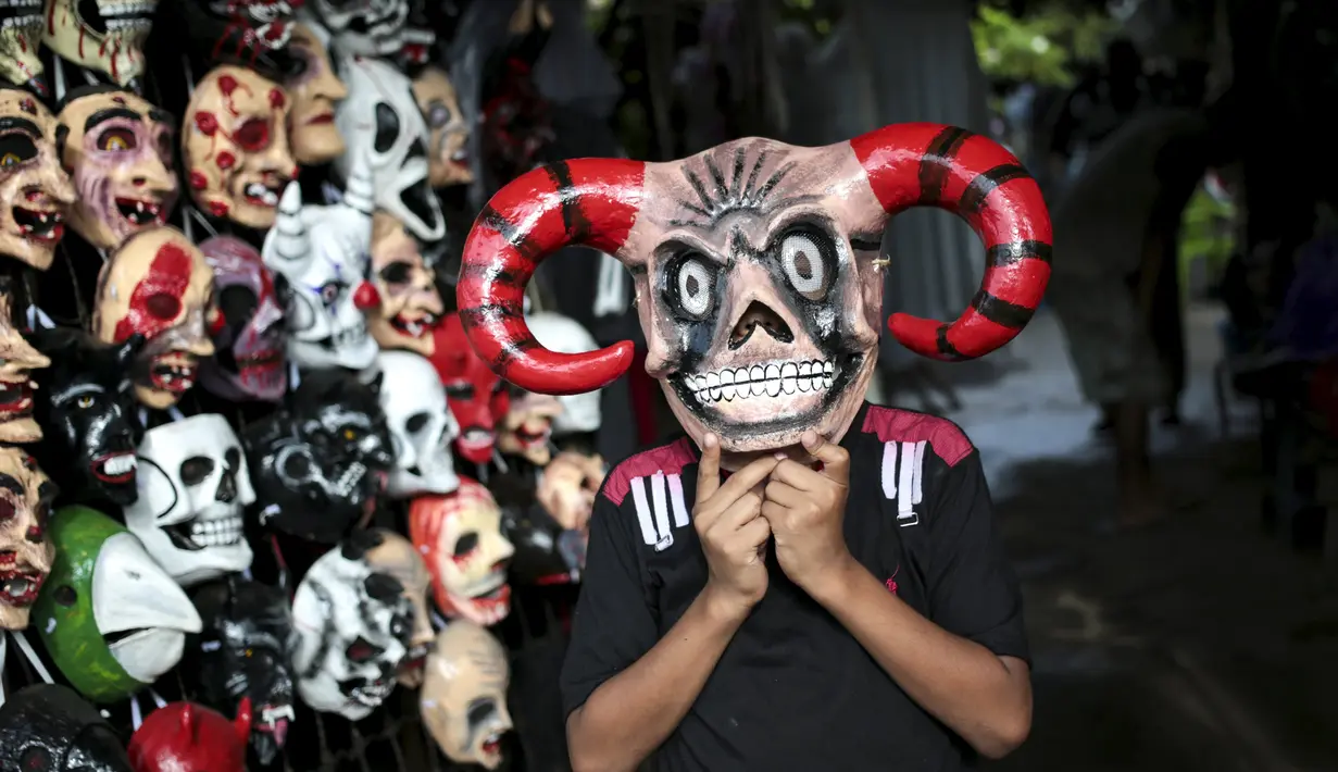Seorang anak mengenakan topeng mirip iblis selama festival Los Aguizotes di Masaya, Nikaragua, Jumat (18/10/2015).  Festival  ini menganjurkan para warganya untuk berpakaian layaknya karakter dari legenda dan mitologi Nikaragua.  (REUTERS/Oswaldo Rivas)