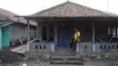 Seorang pria duduk di depan rumahnya di dusun Regahan Lada, Pulau Sebesi, Lampung, Senin (31/12). Banyak warga dusun ini yang bertahan dan enggan meninggalkan rumahnya pascatsunami Selat Sunda pada 22 Desember lalu. (Liputan6.com/Herman Zakharia)