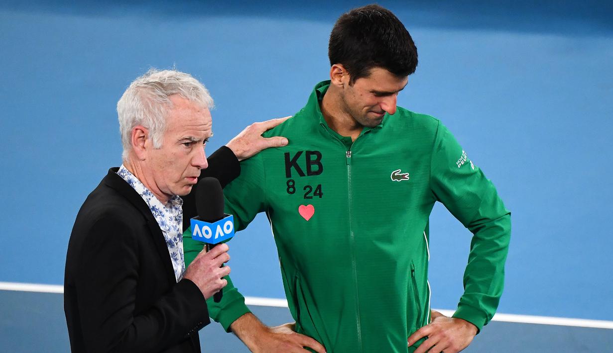 Petenis Serbia, Novak Djokovic, menangis saat diwawancara tentang Kobe Bryant seusai laga Australia Open 2020 di Melbourne, Selasa (28/1). Beri penghormatan dirinya memakai jaket inisial Kobe Bryant. (AFP/William West)