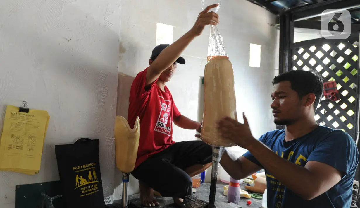 Ortotis prostetis atau pembuat kaki tangan palsu menyelesaikan pekerjaannya di sebuah bengkel kawasan Ciputat Baru, Tangerang Selatan, Banten, Senin (14/10/2019). Kaki dan tangan palsu tersebut dijual dengan harga Rp 5 juta hingga Rp 50 juta. (merdeka.com/Arie Basuki)