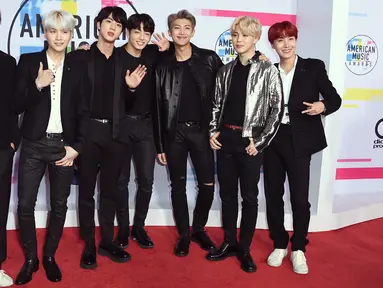 Boyband Korea Selatan, Bangtan Boys alias BTS berpose di karpet merah ajang American Music Awards 2017 di Los Angeles, Minggu (19/11). Grup beranggotakan tujuh personel itu kompak mengenakan busana keluaran Saint Laurent. (Jordan Strauss/Invision/AP)