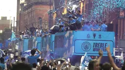 Manchester City menggelar parade keberhasilan mereka memenangkan treble winners musim ini. Suasana Kota Manchester menjadi penuh dengan warna biru langit. (AP Photo/Jon Super)