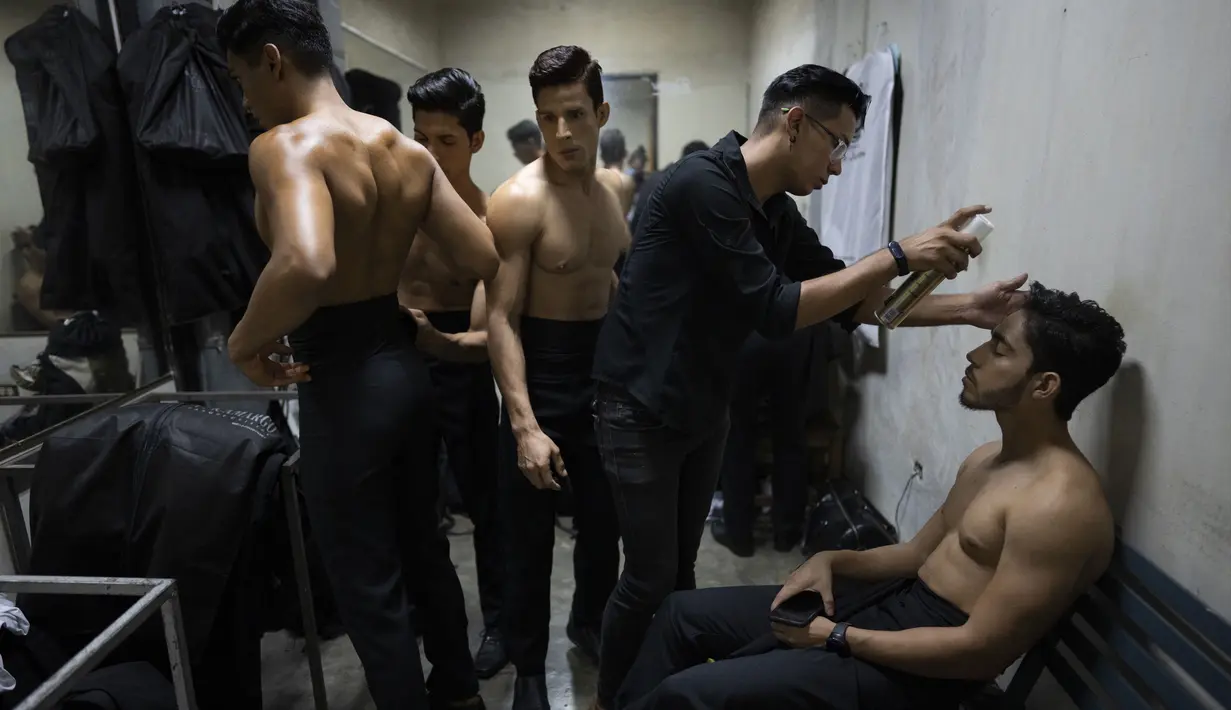 Para kontestan bersiap di belakang panggung untuk Mister Handsome Venezuela di Caracas, Venezuela, 30 Oktober 2021. Kontes kecantikan pria tersebut berlangsung setelah edisi tahun lalu dibatalkan karena pandemi COVID-19. (AP Photo/Ariana Cubillos)