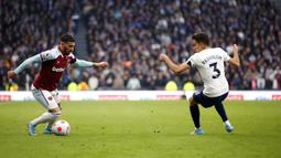 Pemain West Ham United Said Benrahma (kiri) berebut bola dengan pemain Tottenham Hotspur Sergio Reguilon pada pertandingan sepak bola Liga Inggris di Tottenham Hotspur Stadium, London, Inggris, Minggu (20/3/2022). Tottenham Hotspur menang 3-1. (AP Photo/David Cliff)