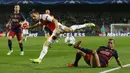 Bek sayap Barcelona, Dani Alves, melakukan tekel kepada bek sayap Arsenal, Nacho Monreal, pada laga leg kedua babak 16 besar Liga Champions di Stadion Camp Nou, Kamis (16/3/2016) dini hari WIB. (Reuters/Albert Gea)