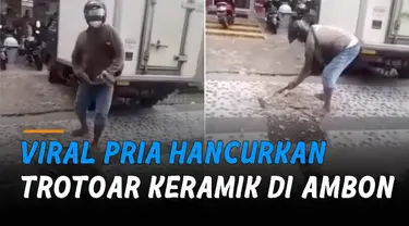 Pria itu menghancurkan trotoar berbahan keramik dengan martil sembari berteriak.