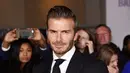 Berpose dengan satu tangan di sakunya, David Beckham berhasil menonjolkan sepasang jas dan celana hitamnya dengan baik, tak lupa dengan dasi hitam yang serasi di dadanya. (via dailymail.co.uk)