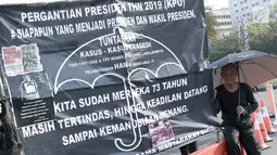 Massa Jaringan Solidaritas Korban untuk Keadilan (JSKK) duduk di samping spanduk saat menggelar aksi Kamisan di depan Istana Negara, Jakarta, Kamis (30/8). Aksi ini memasuki yang ke-551. (Liputan6.com/Immanuel Antonius)