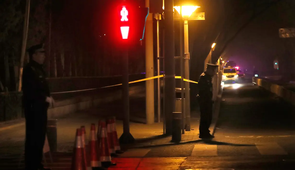 Polisi berjaga di persimpangan dekat Wisma Negara Diaoyutai, Beijing, China, Senin (26/3). Media Jepang menyebut kereta khusus dari Korea Utara yang tiba di Beijing membawa pejabat senior. (AP Photo/Ng Han Guan)