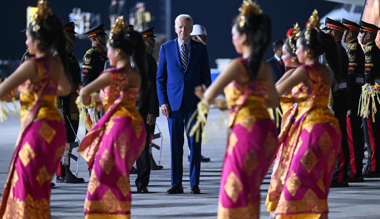 Presiden Amerika Serikat (AS) Joe Biden disambut oleh tarian khas Bali saat turun dari pesawat kepresidenan AS, Air Force One setibanya di Bandara I Gusti Ngurah Rai Bali, Minggu (13/11/2022). Satu per satu tamu undangan perhelatan acara puncak Konferensi Tingkat Tinggi (KTT) G20 mulai berdatangan. (Photo by SAUL LOEB / AFP)