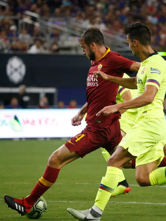 Gelandang AS Roma, Bryan Cristante berusaha menendang bola dari kawalan bek Barcelona, Juan Brandariz saat bertanding pada ICC 2018 di AT & T Stadium di Arlington, Texas (31/7). Roma menang telak 4-2 atas Barcelona. (AP Photo/Michael Ainsworth)