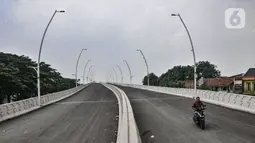 Pengendara sepeda motor saat melintas di jalan layang (Flyover) Cakung, Jakarta Timur, Selasa (16/3/2021). Progres pembangunan flyover yang menghubungkan kawasan Duren Sawit dengan Cakung tersebut saat ini telah mencapai 96,44 persen. (merdeka.com/Iqbal S. Nugroho)