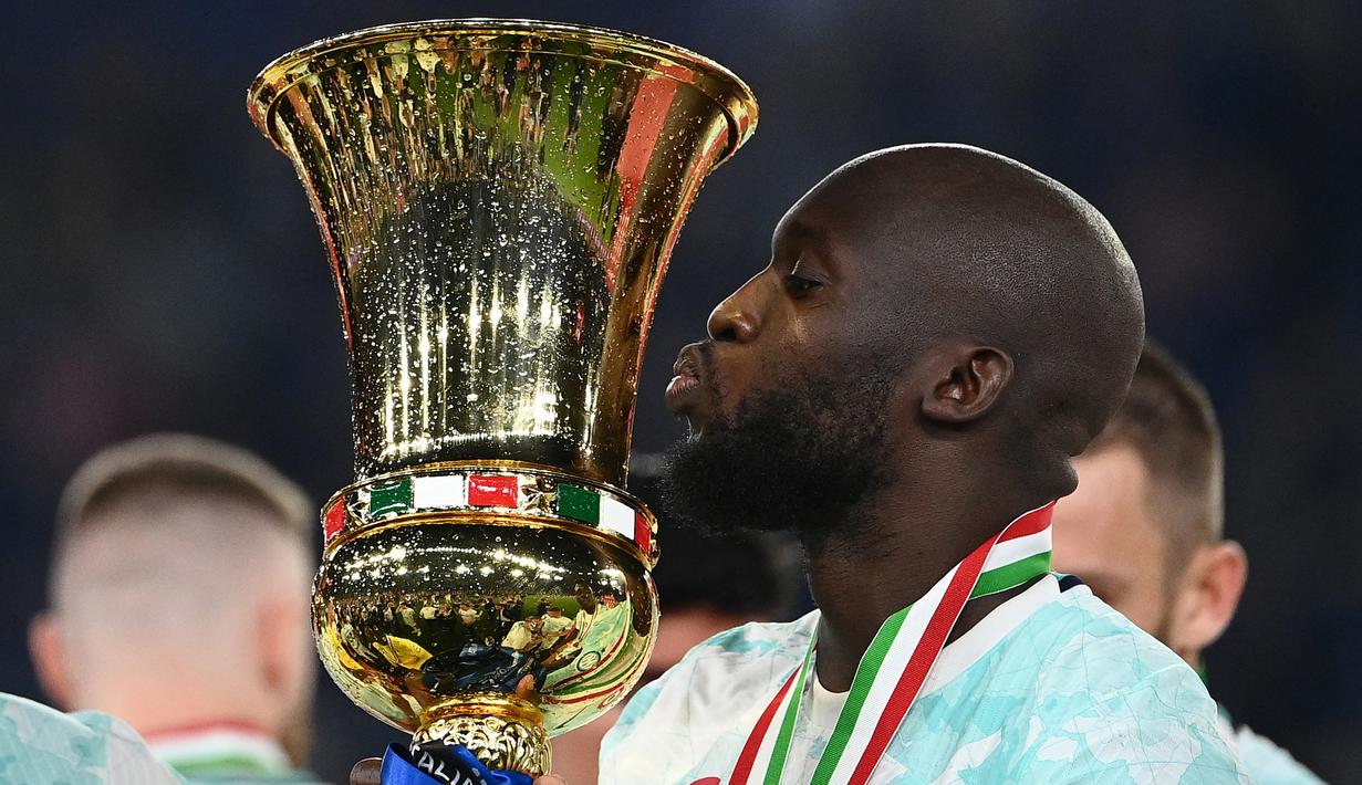 Selebrasi striker Inter Milan, Romelu Lukaku dengan mencium trofi Coppa Italia 2022/2023 setelah mengalahkan Fiorentina pada laga final di Olimpic Stadium, Roma (24/5/2023). Al Hilal sempat menawari Romelu Lukaku  untuk meninggalkan Chelsea dengan nilai kontrak 45 juta poundsterling atau setara Rp818 miliar selama dua tahun. Dengan alasan masih ingin bermain di Eropa, Romelu Lukaku pun menolaknya. (AFP/Isabella Bonotto)