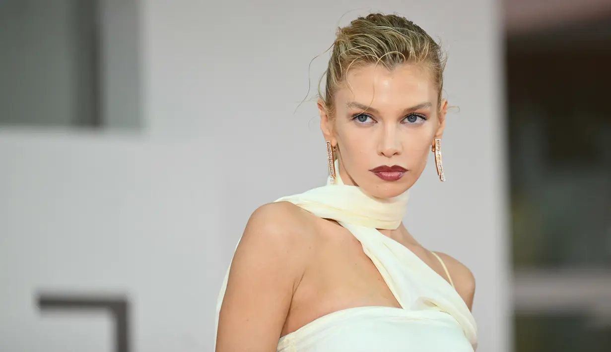 Bintang catwalk ini memilih lipstik merah tua yang mencolok dan berpose seksi di acara tersebut. (Alberto PIZZOLI / AFP)
