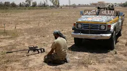 Pasukan tentara Libya melaksanakan salat disela-sela pertempuran sengit melawan militan ISIS untuk merebut kembali kota Sirte, Libya, (21/7). Dalam pertempuran tersebut, 13 anggota ISIS tewas dan lebih dari 110 orang terluka. (REUTERS/Goran Tomasevic)