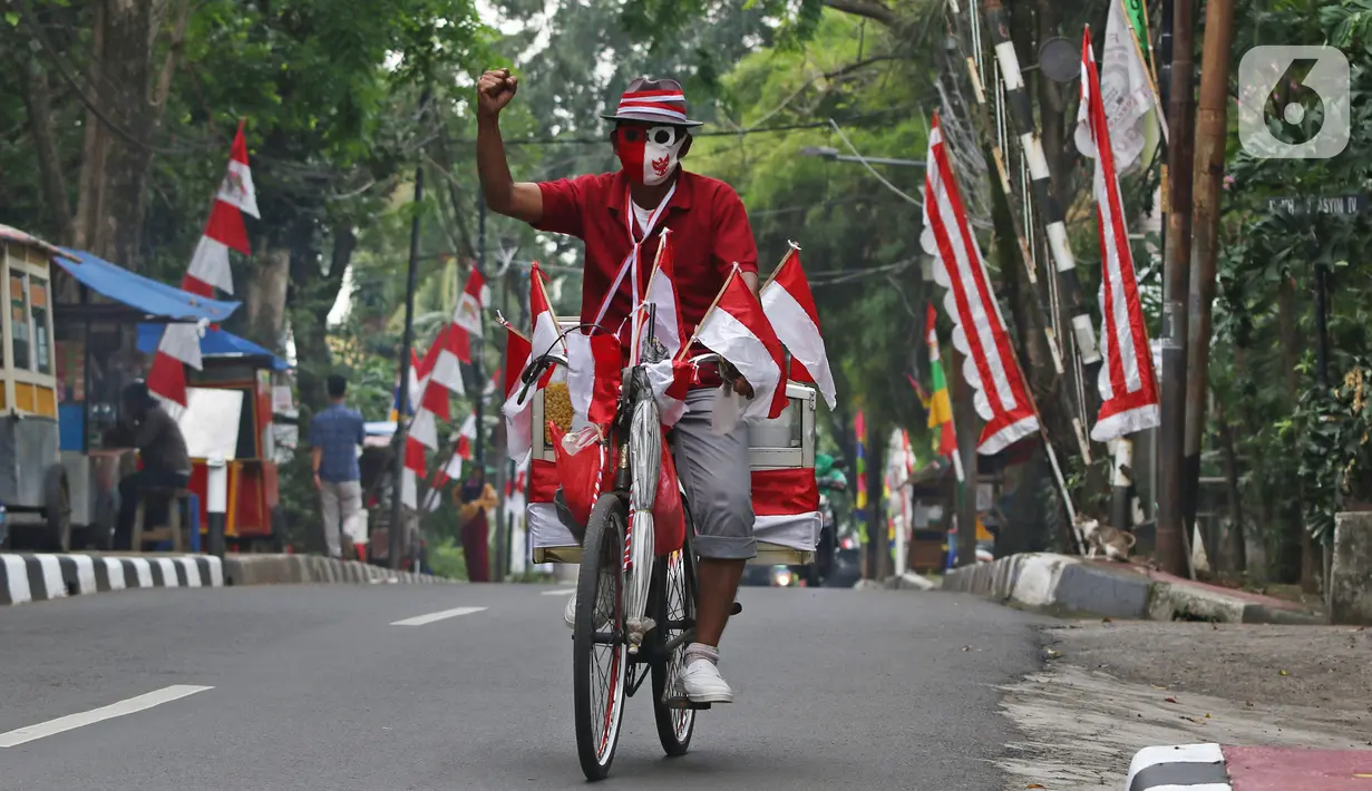 Pedagang jagung manis, Tarjono saat berjualan di kawasan Cilandak, Jakarta, Kamis (13/8/2020). Tarjono memodifikasi sepeda yang dipakainya untuk berjualan dengan atribut kemerdekaan dalam rangka memperingati HUT ke-75 RI, serta mengajak warga memasang bendera di rumah. (Liputan6.com/Herman Zakharia)