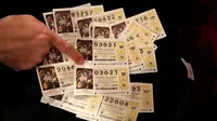 Sejumlah lembaran kertas lotre para peserta El Gordo  di Spanyol, Selasa (22/12). Panitia menyediakan sekitar Ratusan Miliar rupiah untuk bursa lotre terbesar di Spanyol ini.(REUTERS/Andrea Comas)