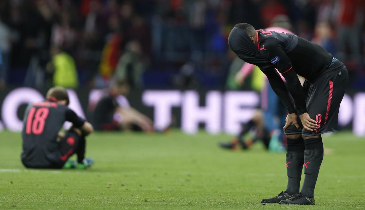 Pemain Arsenal, Alexandre Lacazette (kanan) menutup wajahnya usai kalah dari Atletico pada semifinal Liga Europa di Wanda Metropolitano stadium, Madrid, (3/5/2018). Atletico menang 1-0. (AP/Francisco Seco)