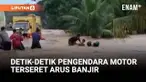 Seorang pengendara sepeda motor terseret arus banjir yang menggenangi jalan lintas Kecamatan Palembayan, Kabupaten Agam, Sumatera Barat, Selasa sore.