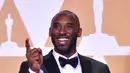 Kobe Bryant berpose sambil memegang Piala Oscar 2018 usai meraih penghargaan di Academy Awards ke-90 di Hollywood, California (3/4). Bryant berhasil merebut satu piala untuk kategori film animasi pendek terbaik. (AFP/Frederic J. Brown)