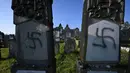 Lambang swastika Nazi pada nisan di pemakaman Yahudi, Westhoffen, dekat Strasbourg, Prancis, Rabu (4/12/2019). Sedikitnya 107 makam menjadi sasaran vandalisme dengan dicoreti lambang swastika Nazi. (AFP/Patrick Hertzog)