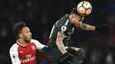 Bek Manchester City, Nicolas Otamendi, membuang bola dari striker Arsenal, Pierre-Emerick Aubameyang, pada laga Premier League di Stadion Emirates, London, Kamis (1/3/2018). Arsenal kalah 0-3 dari City. (AFP/Glyn Kirk)