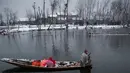 Pedagang berada di perahu membawa dagangannya  di pasar terapung di danau Dal, Srinagar, Kashmir India, (25/1). Pasar ini memulai aktivitasnya saat subuh dan selesai pada pukul 07.00. (AP Photo/Dar Yasin)