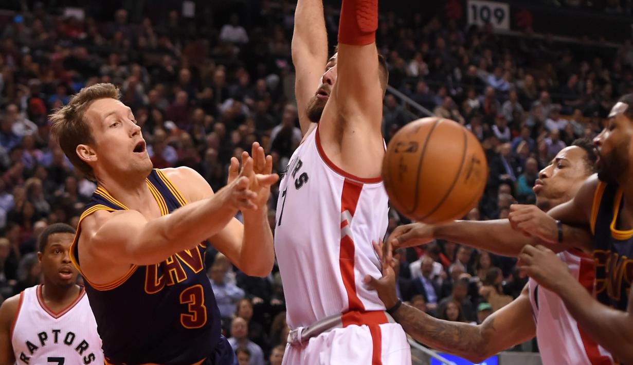 Pemain Cleveland Cavaliers, Mike Dunleavy #3 memberikan umpan kepada rekannya melewati hadangan Raptors, Jonas Valanciunas #17 pada laga NBA di Air Canada Centre, (6/12/2016). (Reuters/Dan Hamilton-USA TODAY Sports)