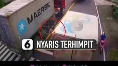 Terekam kamera cctv emak-emak nyaris terhimpit mobil truk besar saat berhenti di lampu merah.