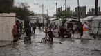 Warga Palestina berjalan di jalanan yang terendam banjir di samping kamp tenda sementara setelah hujan deras di Deir al-Balah, Jalur Gaza tengah, Selasa 25 November 2025. Banjir kembali menggenangi sebagian wilayah Deir al-Balah, Jalur Gaza tengah, pada Selasa 25 November 2025. (AP Photo/Abdel Kareem Hana)