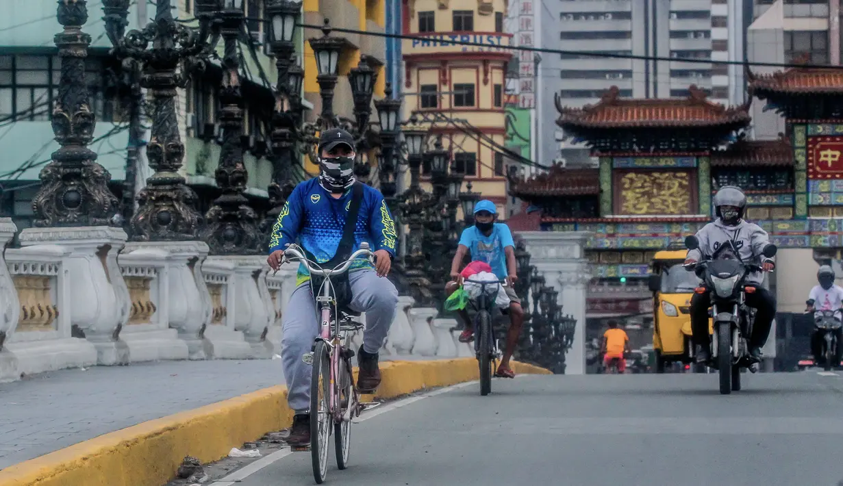 Pesepeda mengenakan masker di Manila, Filipina (2/8/2020). Jumlah kasus terkonfirmasi COVID-19 di Filipina melonjak menjadi 103.185 setelah Departemen Kesehatan negara itu melaporkan total 5.032 kasus baru pada Minggu (2/8). (Xinhua/Rouelle Umali)