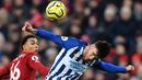 Bek Liverpool, Trent Alexander-Arnold, duel udara dengan striker Brighton, Aaron Connolly, pada laga Premier League di Stadion Anfield, Liverpool, Sabtu (1/12). Liverpool menang 2-1 atas Brighton. (AFP/Paul Ellis)