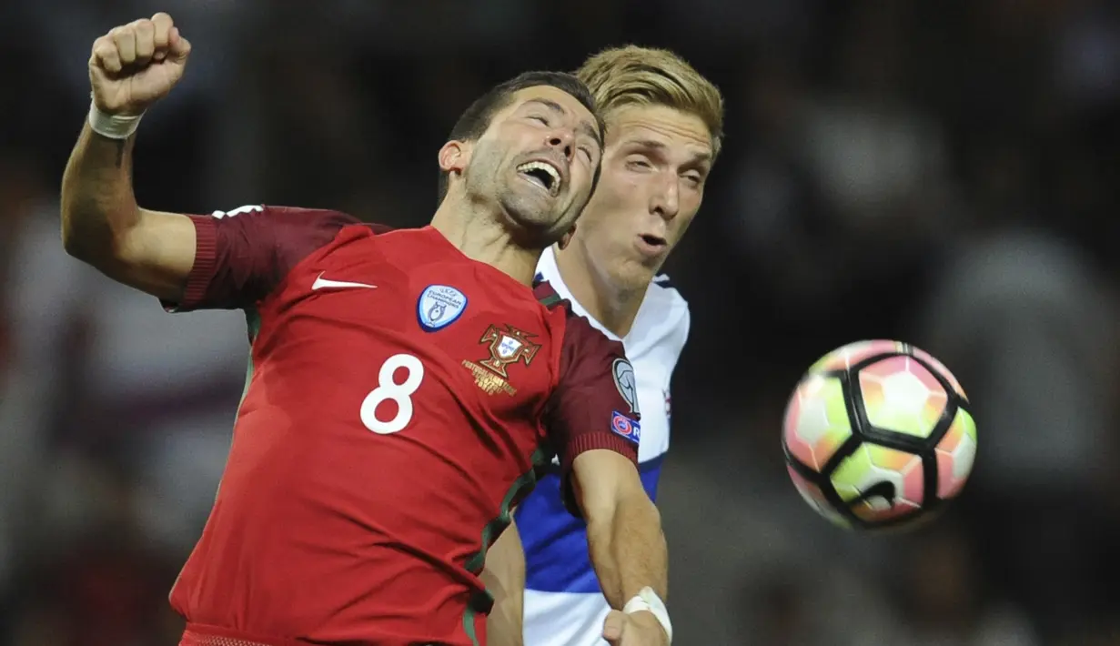 Pemain Portugal, Joao Moutinho (kiri) berebut bola dengan pemain Kepulauan Faroe, Joan Edmundsson pada laga Grup B Kualifikasi Piala Dunia 2018 di Bessa Stadium, Porto, (31/8/2017). Portugal menang 5-1. (AP/Paulo Duarte)
