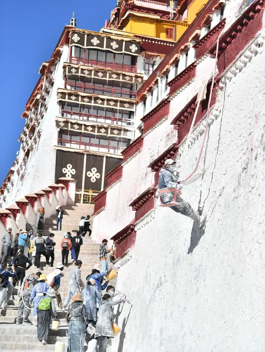 Para pekerja mengecat tembok Istana Potala dalam rangka renovasi tahunan kompleks arsitektur kuno tersebut di Lhasa, ibu kota Daerah Otonom Tibet, China barat daya, pada 28 Oktober 2020. (Xinhua/Jigme Dorji)