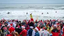 Pengunjung memadati acara Surfing Santa yang berlangsung di Pantai Cocoa, Florida, Amerika Serikat, Selasa (24/12/2024) waktu setempat. (AFP/Giorgio Viera)
