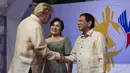Presiden Filipina, Rodrigo Duterte didampingi Ibu Negara, Cielito "Honeylet" Avancena menyambut Presiden AS, Donald Trump dalam acara makan malam bersama konferensi ASEAN ke-31 di Manila, Minggu (12/11). (Athit Perawongmetha/Pool via AP)