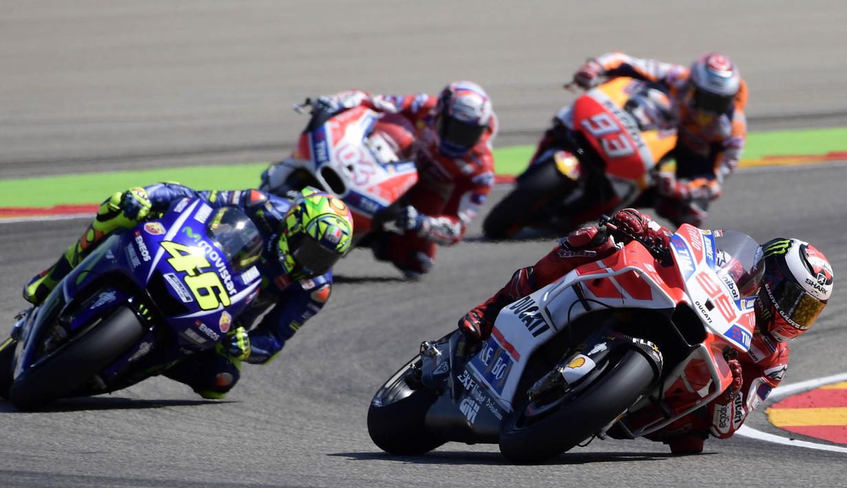 Pebalap Movistar Yamaha, Valentino Rossi, berusaha membalap pebalap Ducati, Jorge Lorenzo pada GP Aragon di Sirkuit Motorland, Alcaniz, Minggu (24/9/2017). Rossi finis kelima dengan waktu 42 menit 12,698 detik. (AFP/Javier Soriano)
