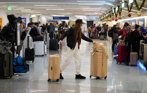 Seorang wanita berjalan ke konter tiket Southwest di Bandara Internasional Los Angeles, Los Angeles, Amerika Serikat, 19 Desember 2022. Liburan Natal dan Tahun Baru bagi sebagian warga Amerika Serikat dan Eropa tahun ini menghadirkan kekhawatiran karena tekanan ekonomi. (AP Photo/Jae C. Hong)