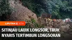 Sebuah truk nyaris tertimbun longsor saat melintasi jalur Sitinjau Lauik, Kota Padang, Sumatra Barat, Jumat siang. Material longsor menutupi jalan dan membuat jalur alternatif Padang-Bukittinggi ini macet panjang.