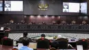 Mahkamah Konstitusi (MK) menolak uji formil Pasal 169 huruf q Undang-Undang Nomor 7 Tahun 2017 tentang Pemilu yang mengatur syarat usia capres dan cawapres yang dimaknai dalam Putusan MK Nomor 90/PUU-XXI/2023. (Liputan6.com/Angga Yuniar)