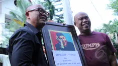 Pembawa acara dan penyanyi, Teuku Edwin dan Jody Sumantri memegang foto almarhum Ferrasta Soebardi alias Pepeng di rumah duka di kawasan Cinere, Depok, Rabu (6/5/2015). Pepeng meninggal dunia di usia 60 tahun. (Liputan6.com/Helmi Afandi)