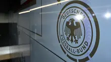 File foto yang diambil pada 22 September 2023 ini memperlihatkan logo Federasi Sepak Bola Jerman (DFB) saat konferensi pers di markas DFB di Frankfurt, Jerman bagian barat. Penyelidik menggerebek markas besar asosiasi sepak bola Jerman dan lokasi lain di seluruh negeri pada 1 Juli 2026 sebagai bagian dari penyelidikan korupsi terkait turnamen Euro 2024. DFB mengonfirmasi bahwa kantor pusatnya di Frankfurt telah menjadi sasaran. Kasus ini melibatkan tuduhan bahwa pegawai kota tuan rumah di Jerman diundang secara ilegal ke pertandingan Euro dan menerima tiket dengan syarat menguntungkan dari penyelenggara, kata polisi dan jaksa. (Kirill KUDRYAVTSEV/AFP)