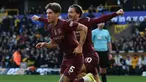 John Stones (kiri) merayakan gol bersama Jack Grealish yang menjadi penentu kemenangan Manchester City atas Wolverhampton 2-1 di laga pekan ke delapan Premier League 2024/2025 di Molineux, Minggu (20/10/2024) malam WIB.